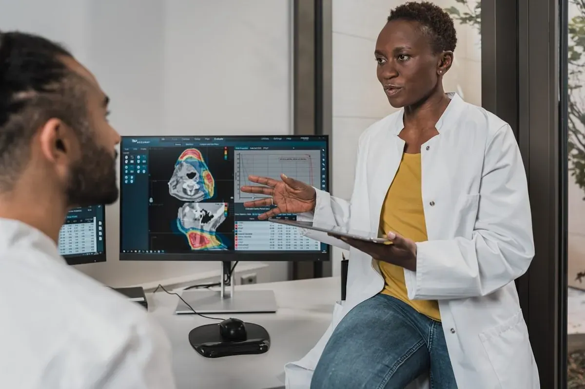 Two doctors looking at a scan on a computer screen
